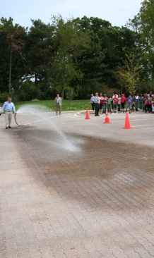 Water sprayed onto a permeable parking lot at Sipley Elementary School, in Woodridge, is absorbed rather than run off.